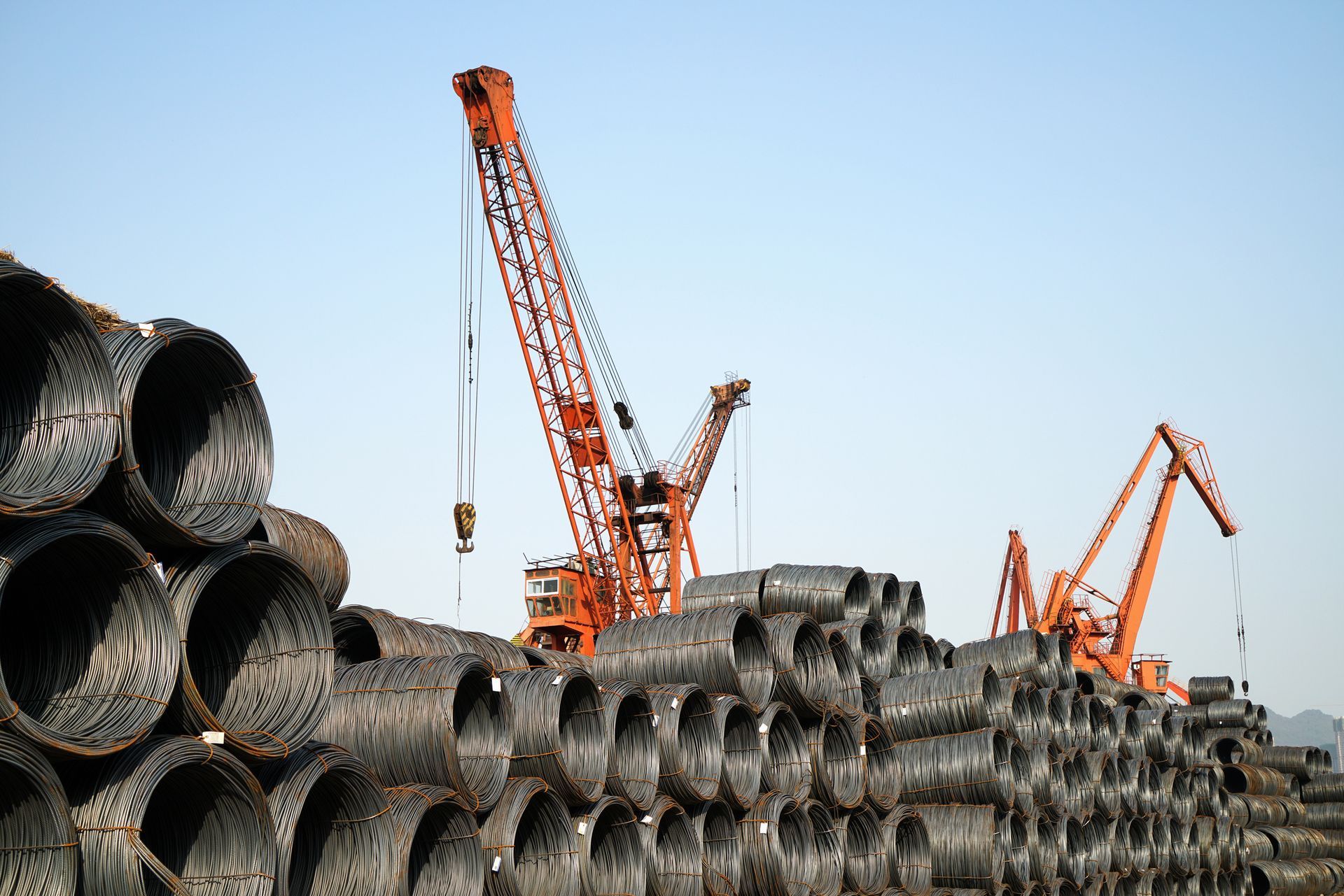A crane behind iron cylinders.