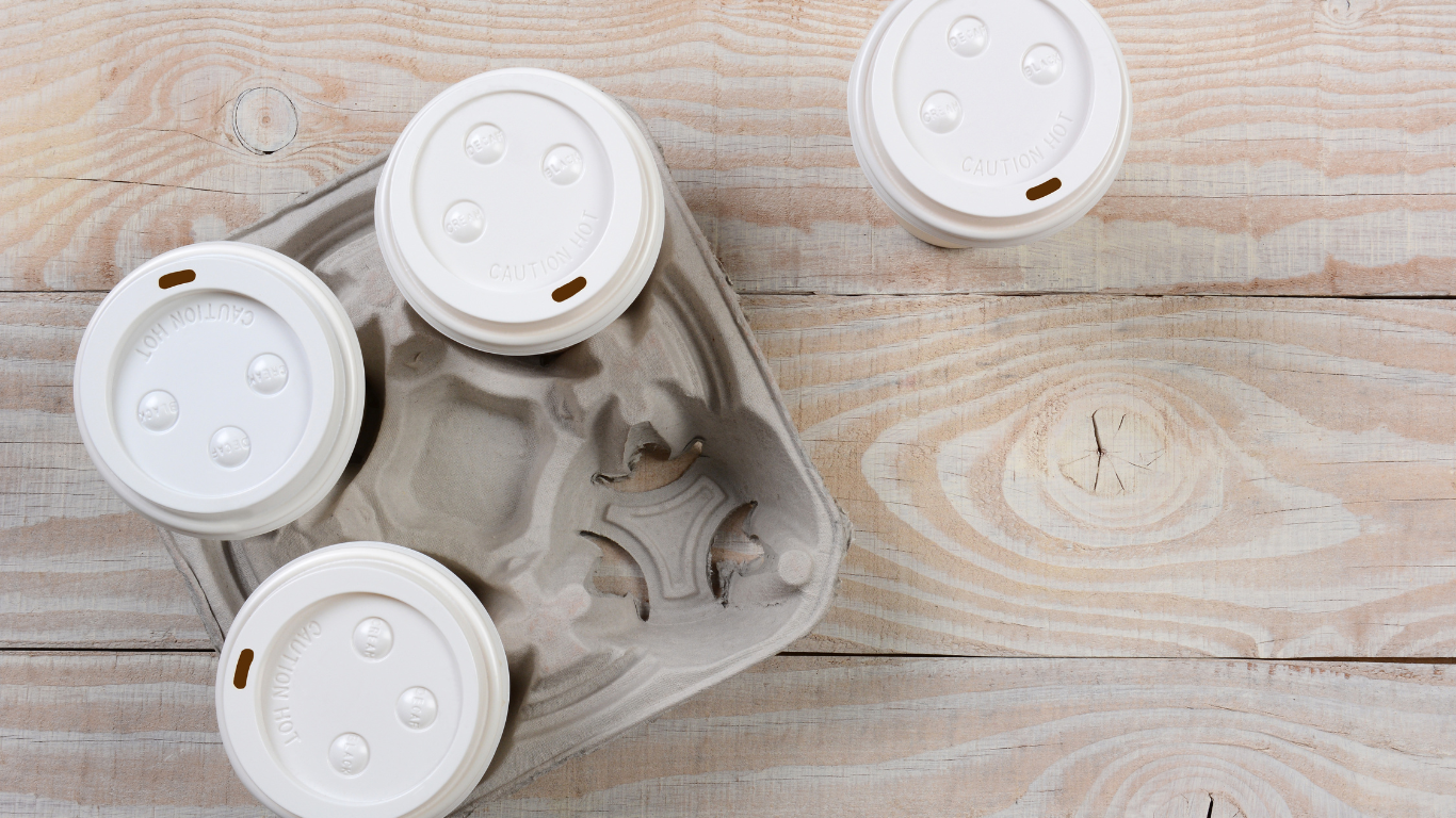 A cup of coffee is sitting on a wooden table.