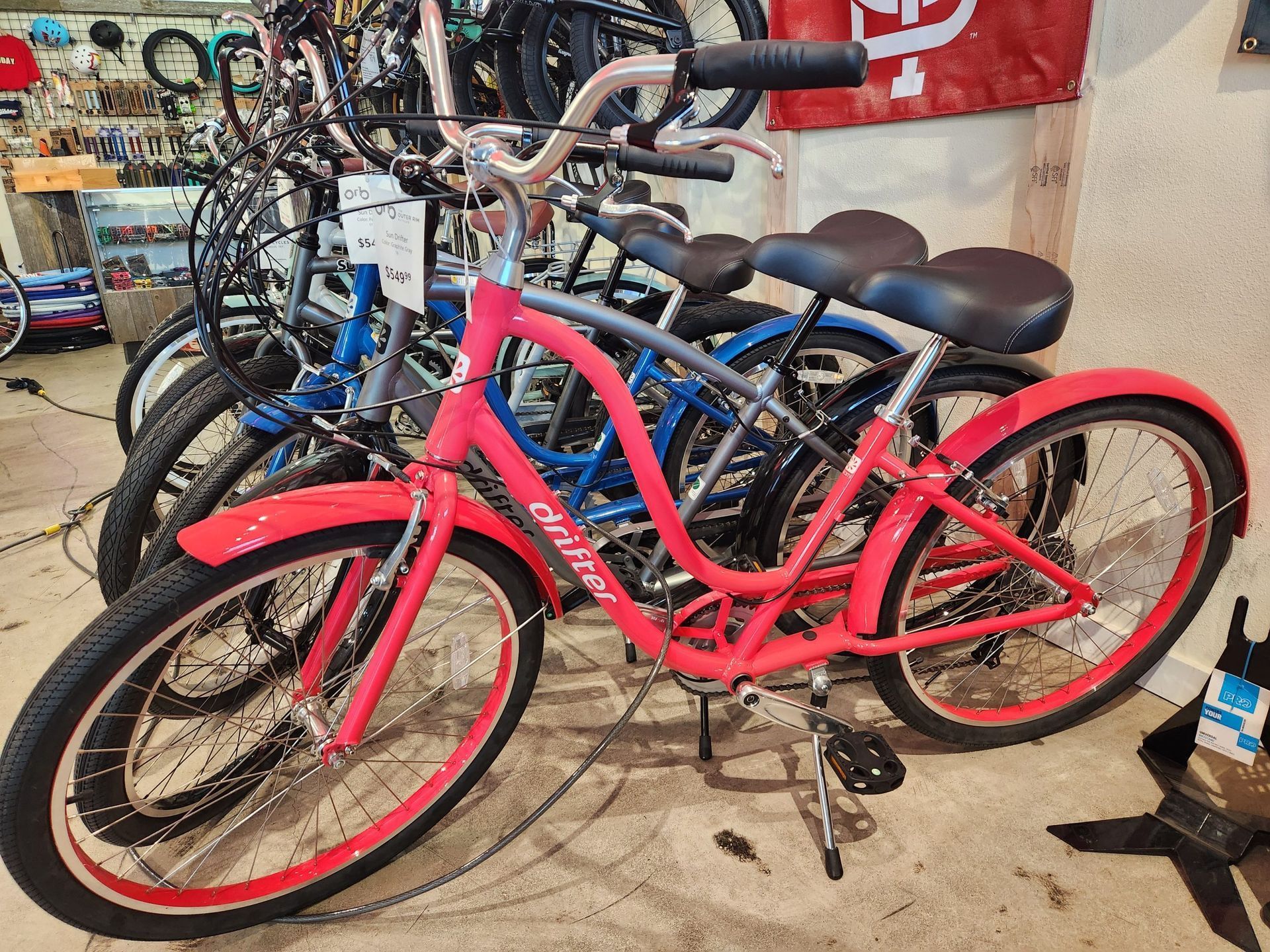 A row of bicycles are lined up in a store.