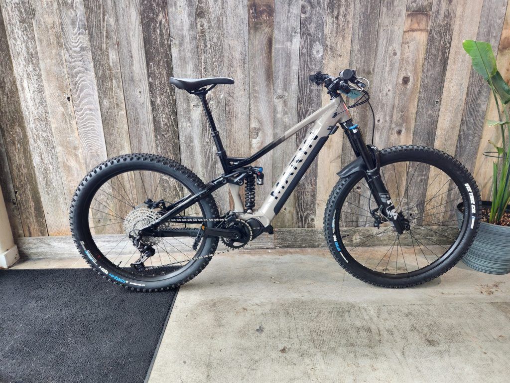 A mountain bike is parked in front of a wooden wall.