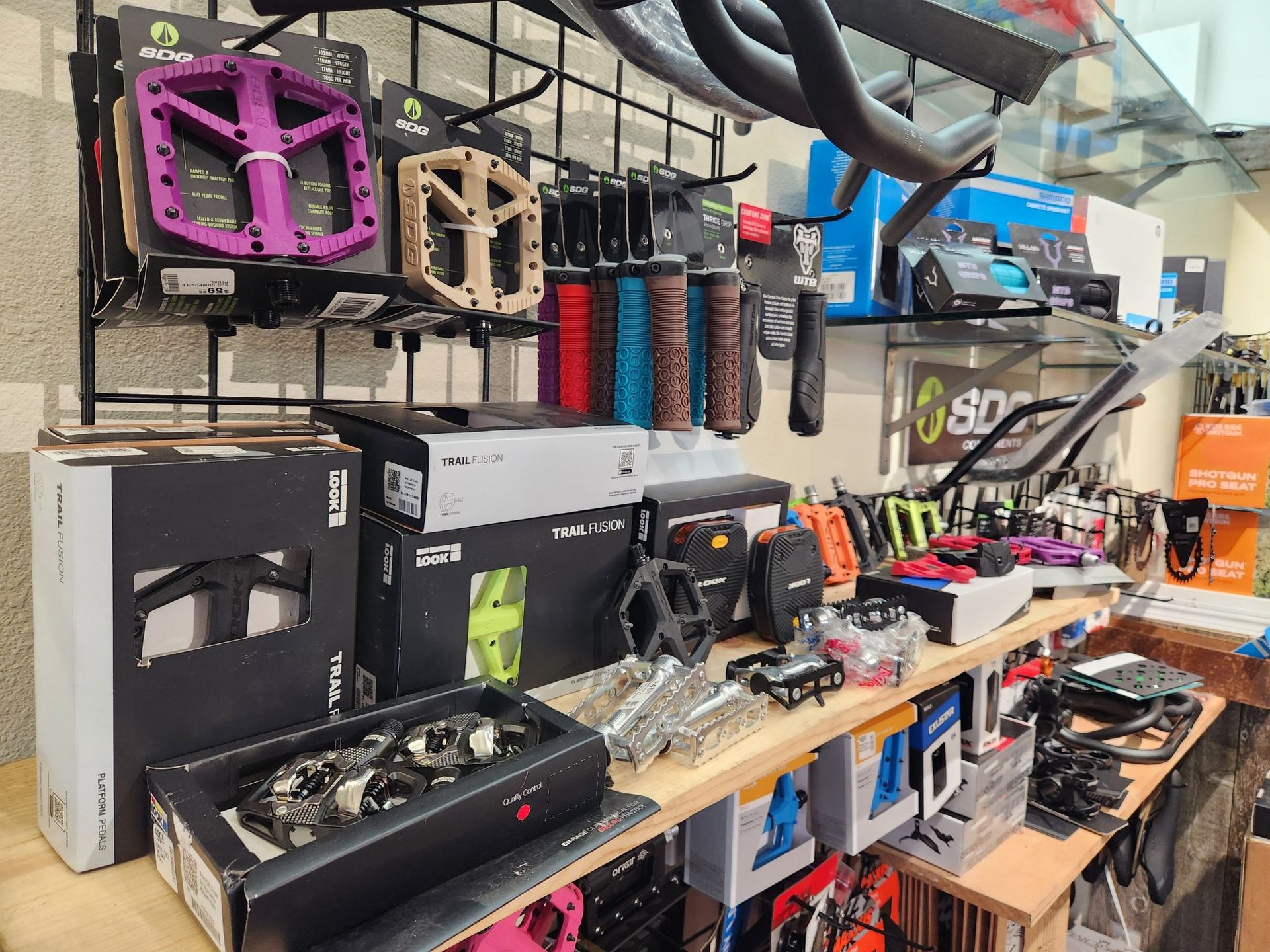 A bicycle shop filled with lots of bicycle parts and pedals.