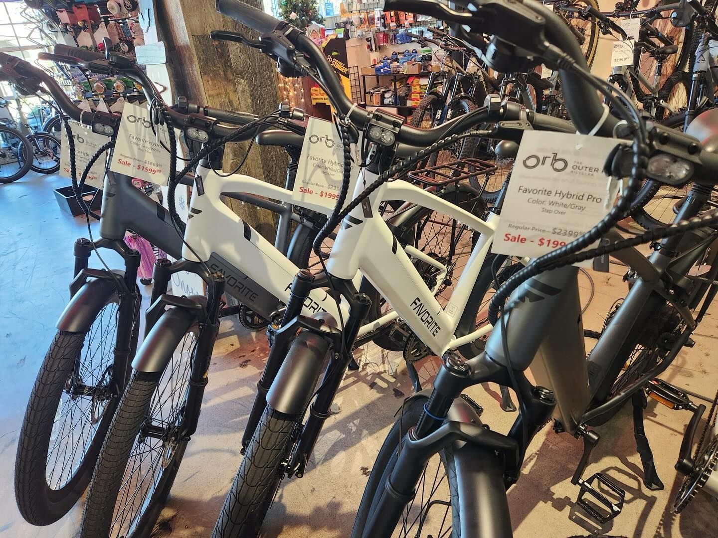 A row of electric bikes are lined up in a store.