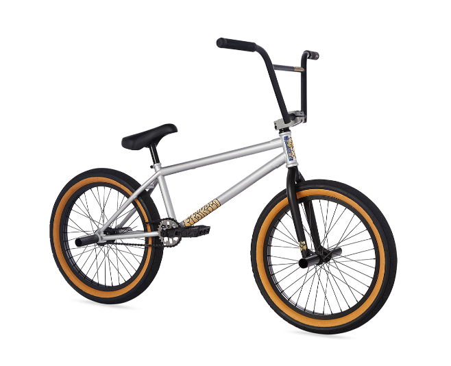 A silver bmx bike with yellow tires on a white background