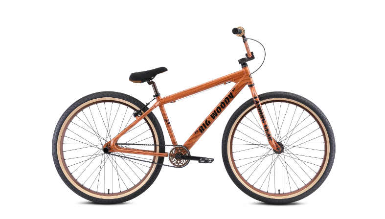 A bicycle is sitting on a white surface.