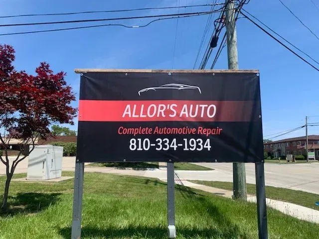 Blue and white commercial building with large windows and an American flag.