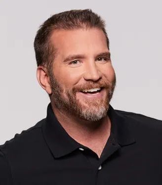 Frank Kramer A man with a beard is wearing a black shirt and smiling.
