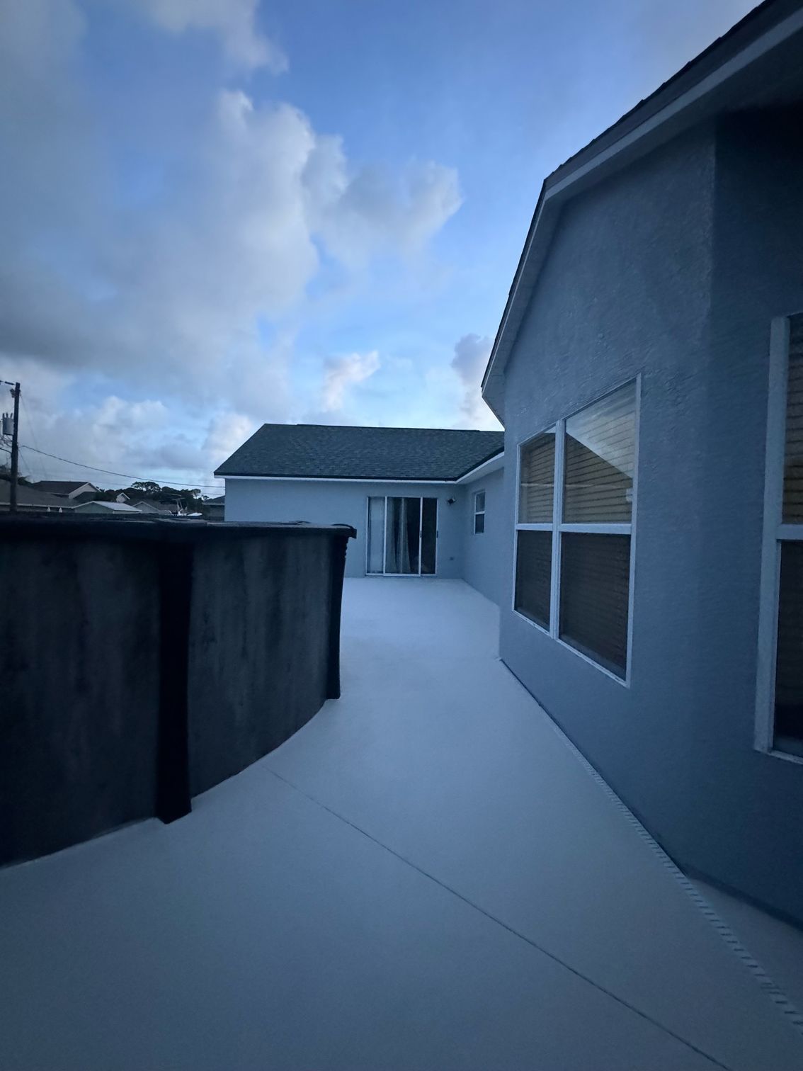 A house with a lot of windows and a blue sky in the background
