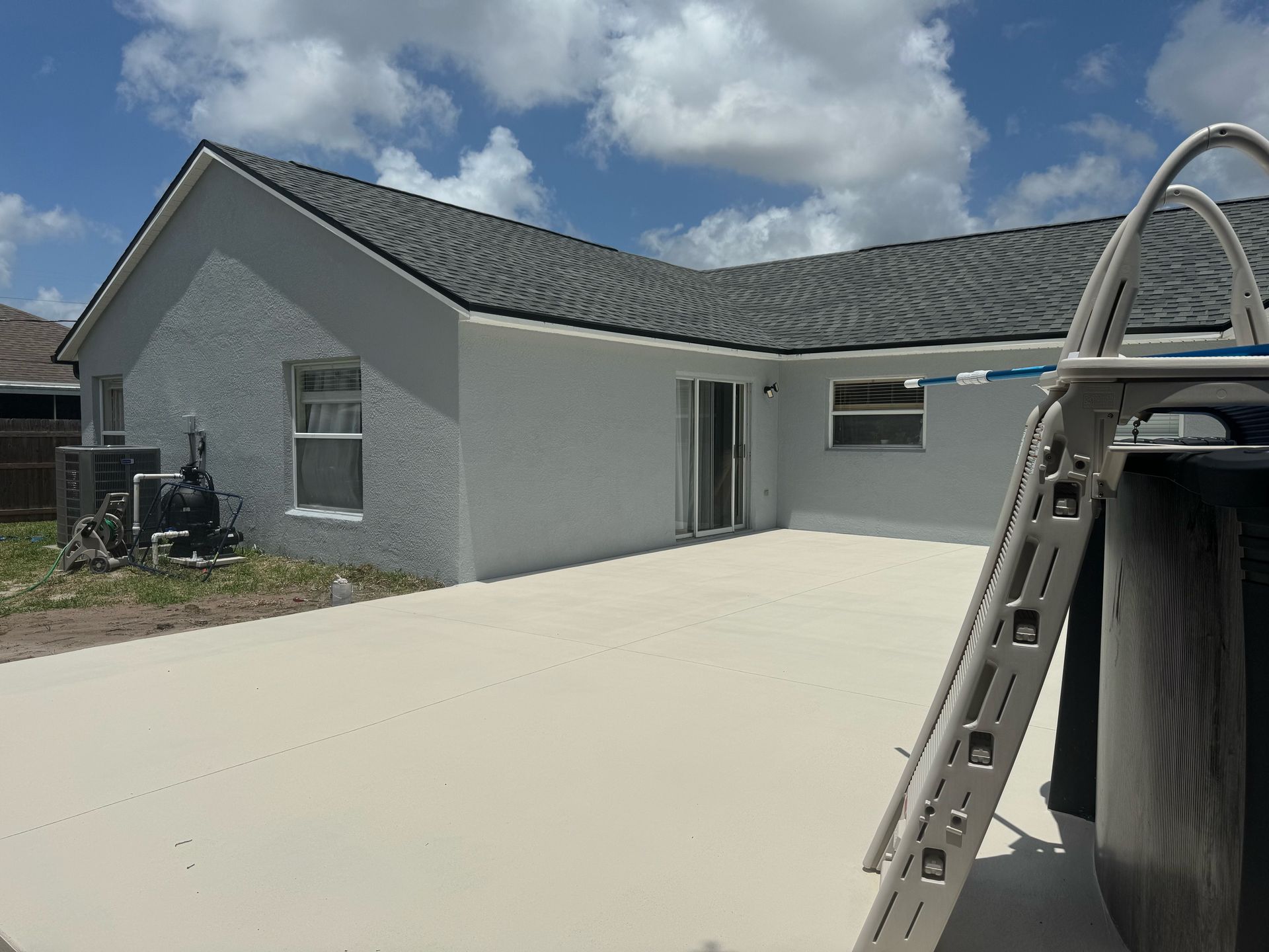 A white house with a ladder in front of it.