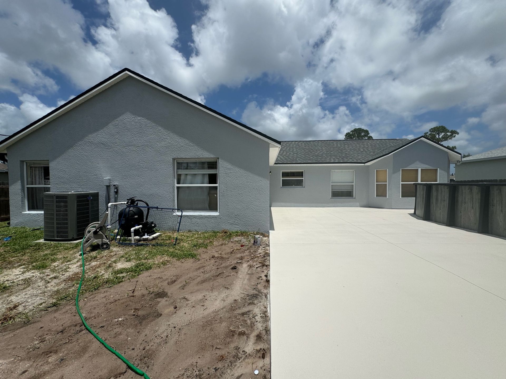 A house with a hose attached to the side of it