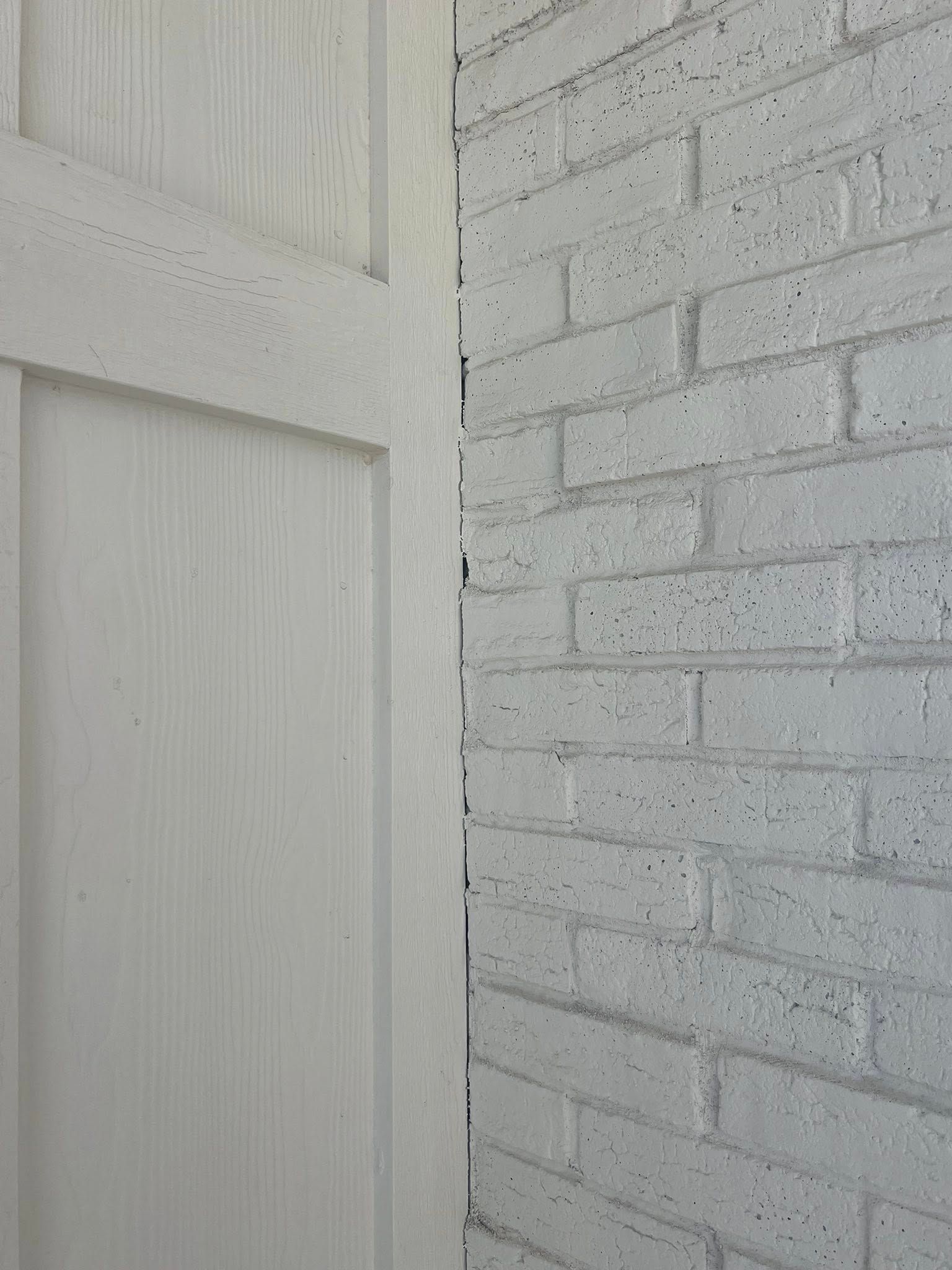 White painted brick wall and door corner.
