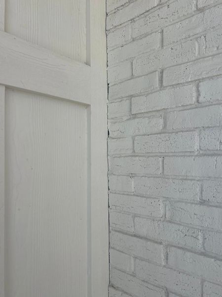 White painted brick wall and door corner.