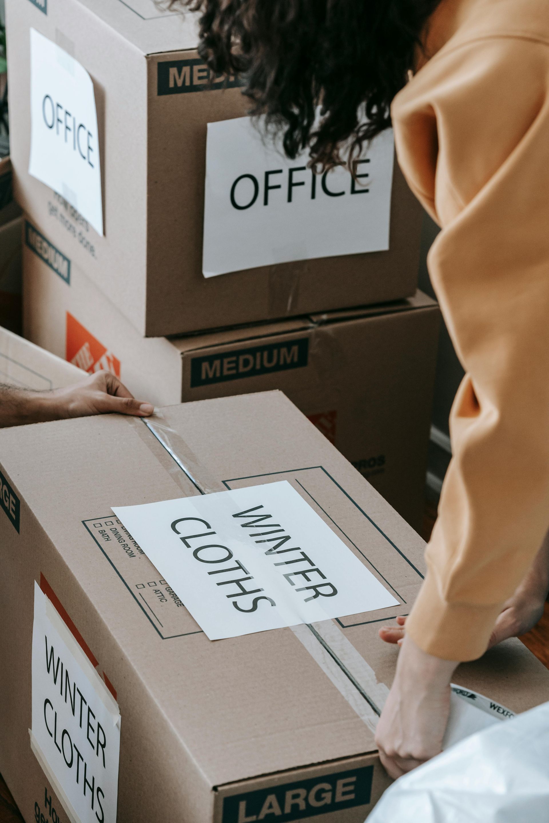 Furniture that has been wrapped in moving pads ready to be carried by movers