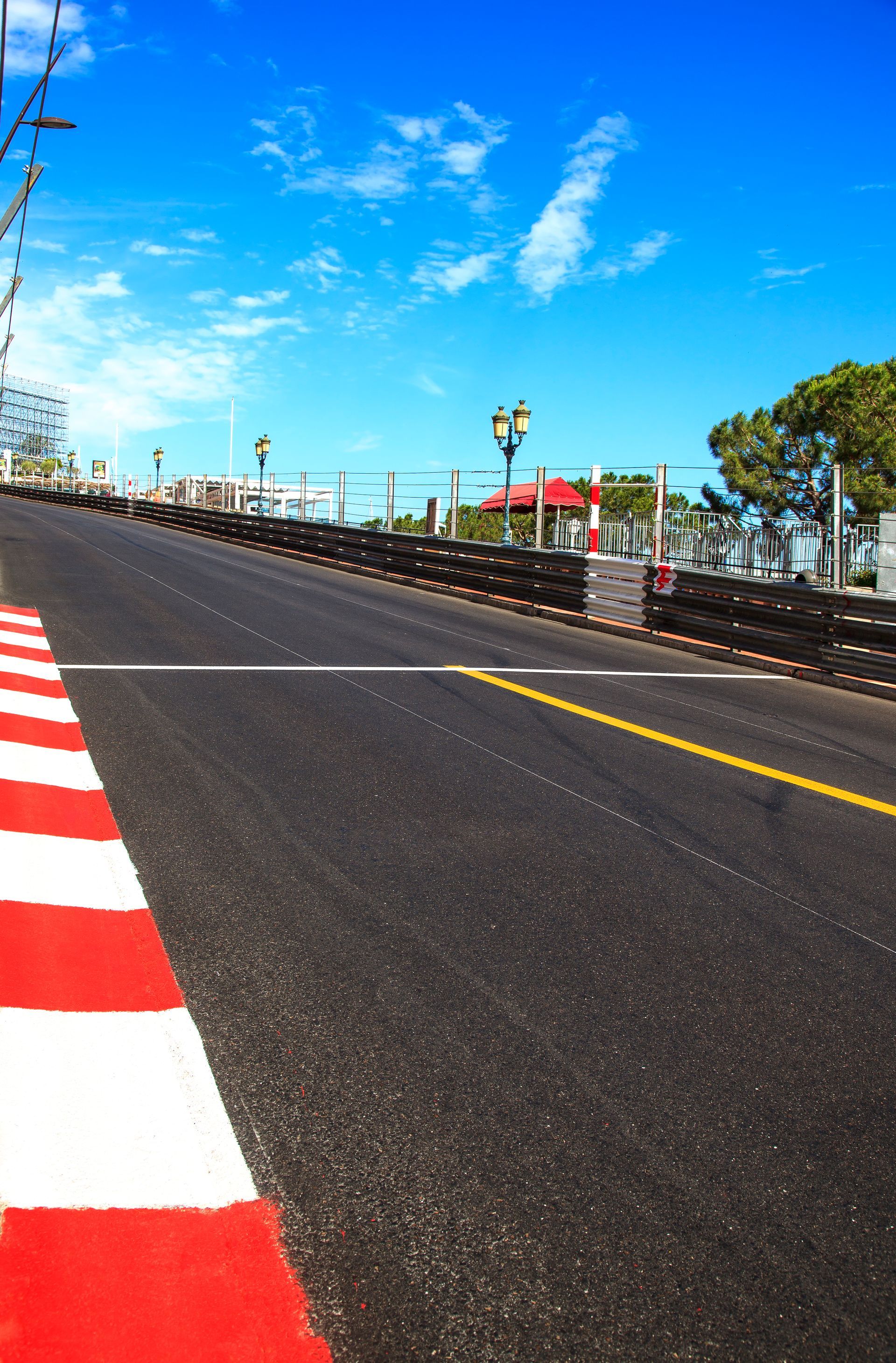A red and white striped road with a blue sky in the background.