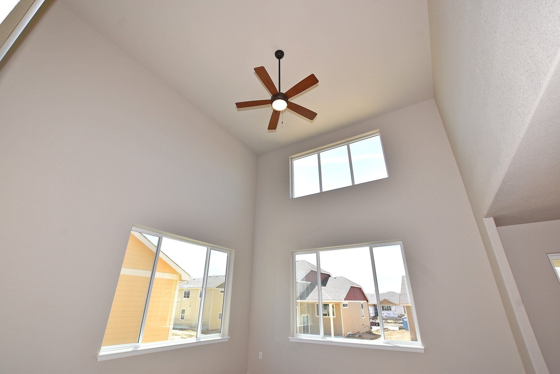 Large room with tall ceiling and fan