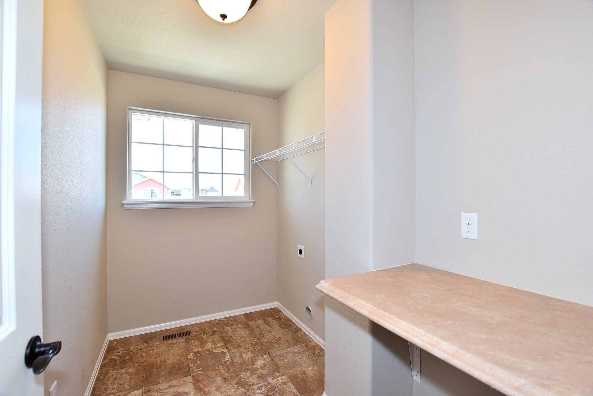 Laundry room with tile flooring