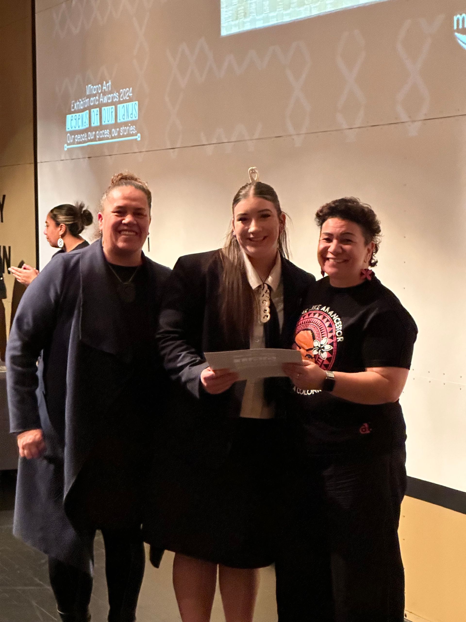 A group of people standing next to each other holding a certificate