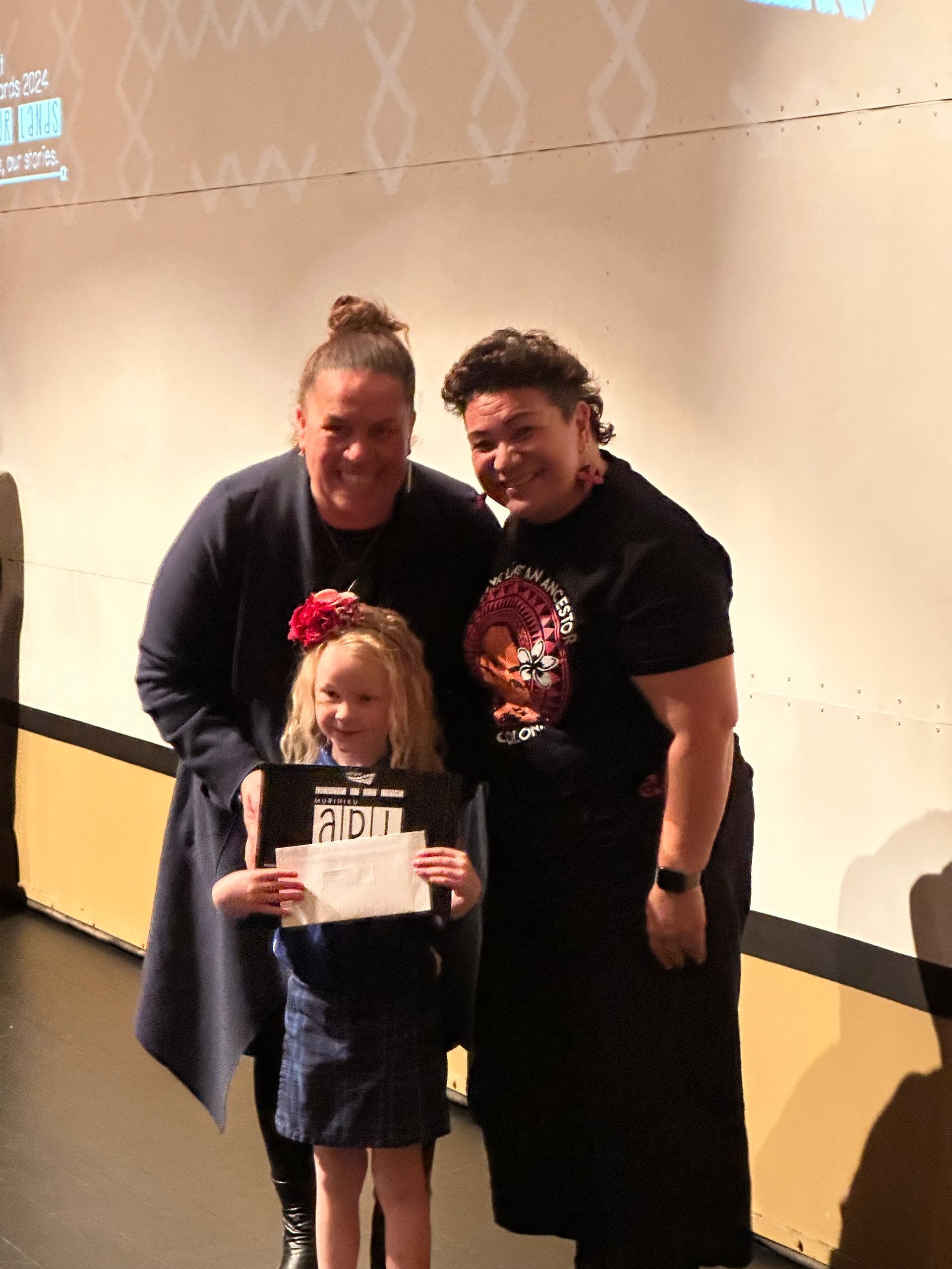 A little girl is holding a certificate