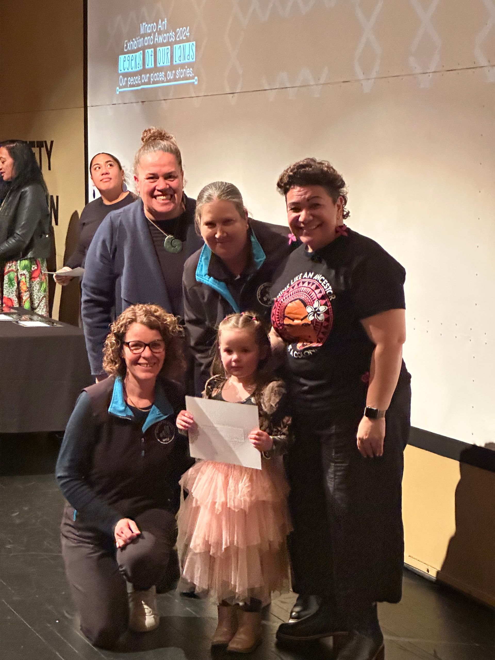 A group of people posing for a picture with a little girl