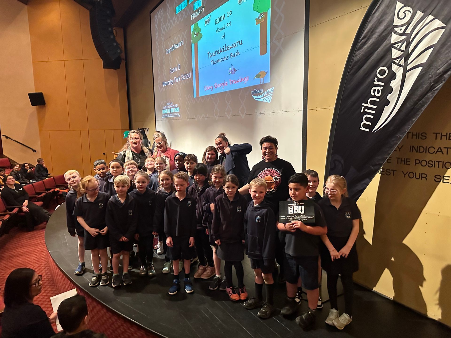 A group of children are standing on a stage.