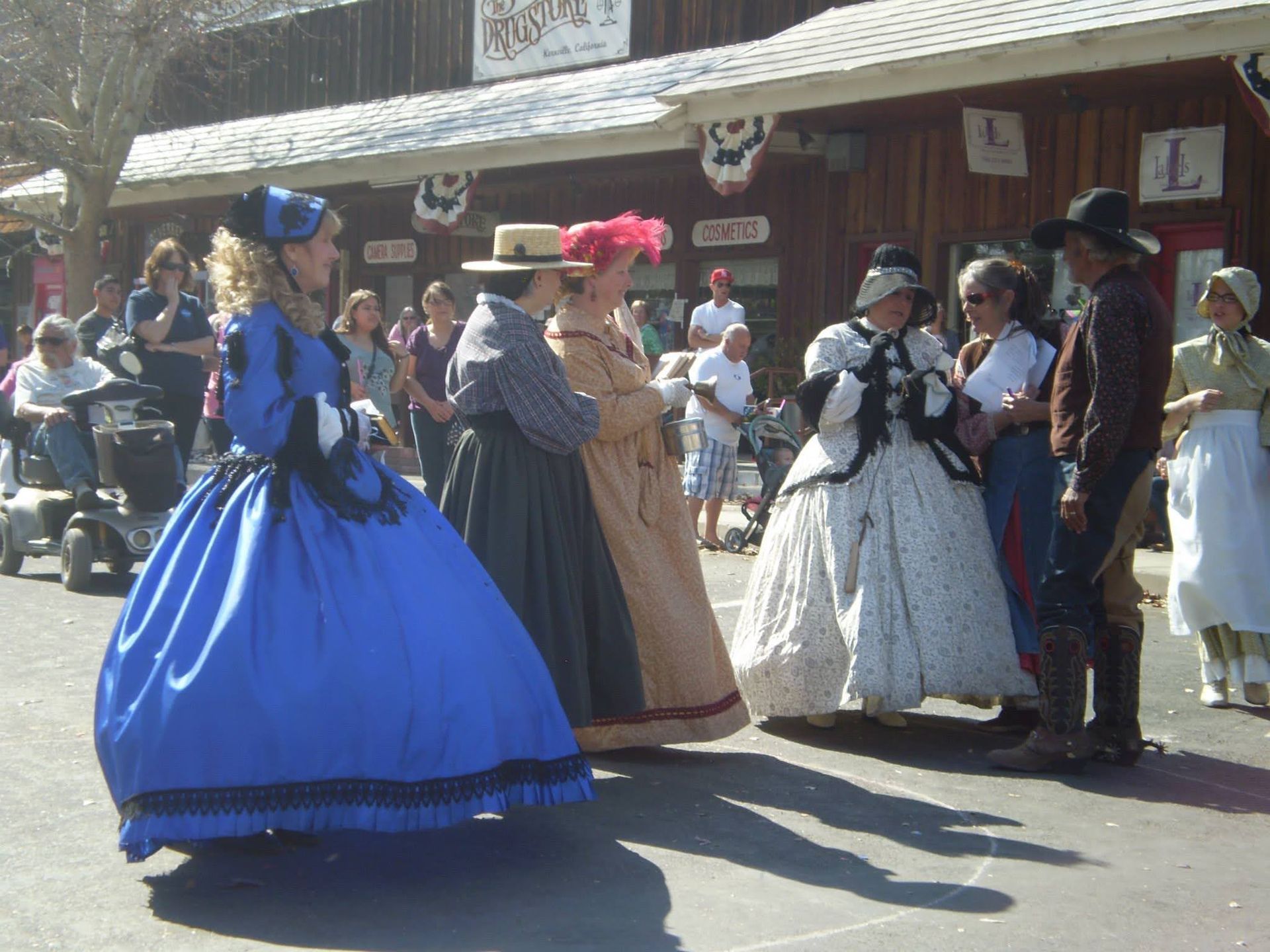 Women in period dress on a small town's main street