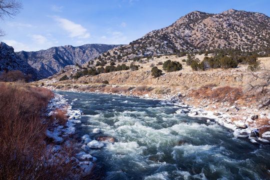 a river with mountains in the background