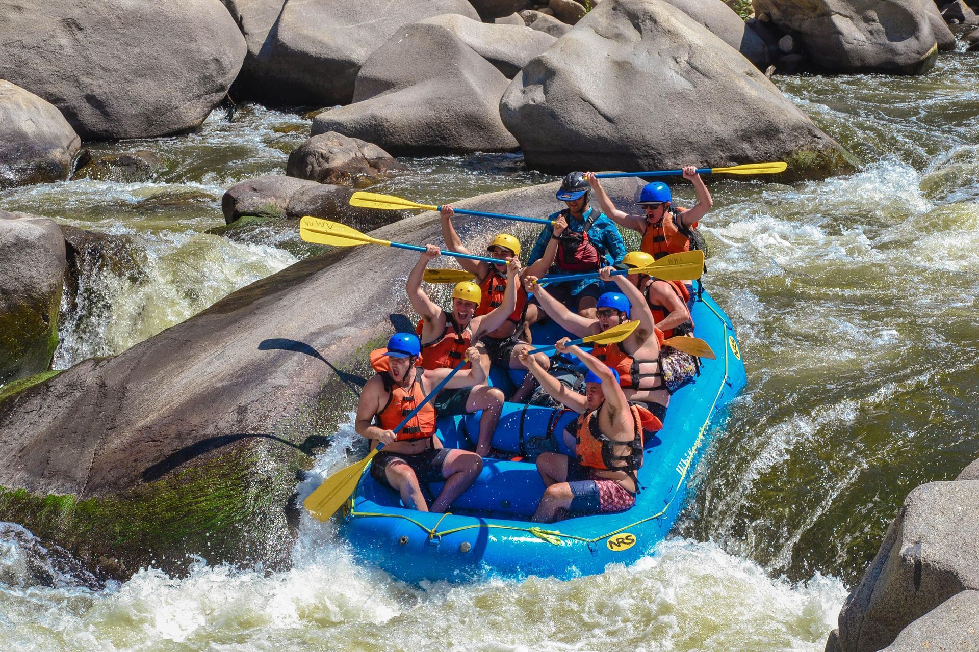 blue raft going down rapids