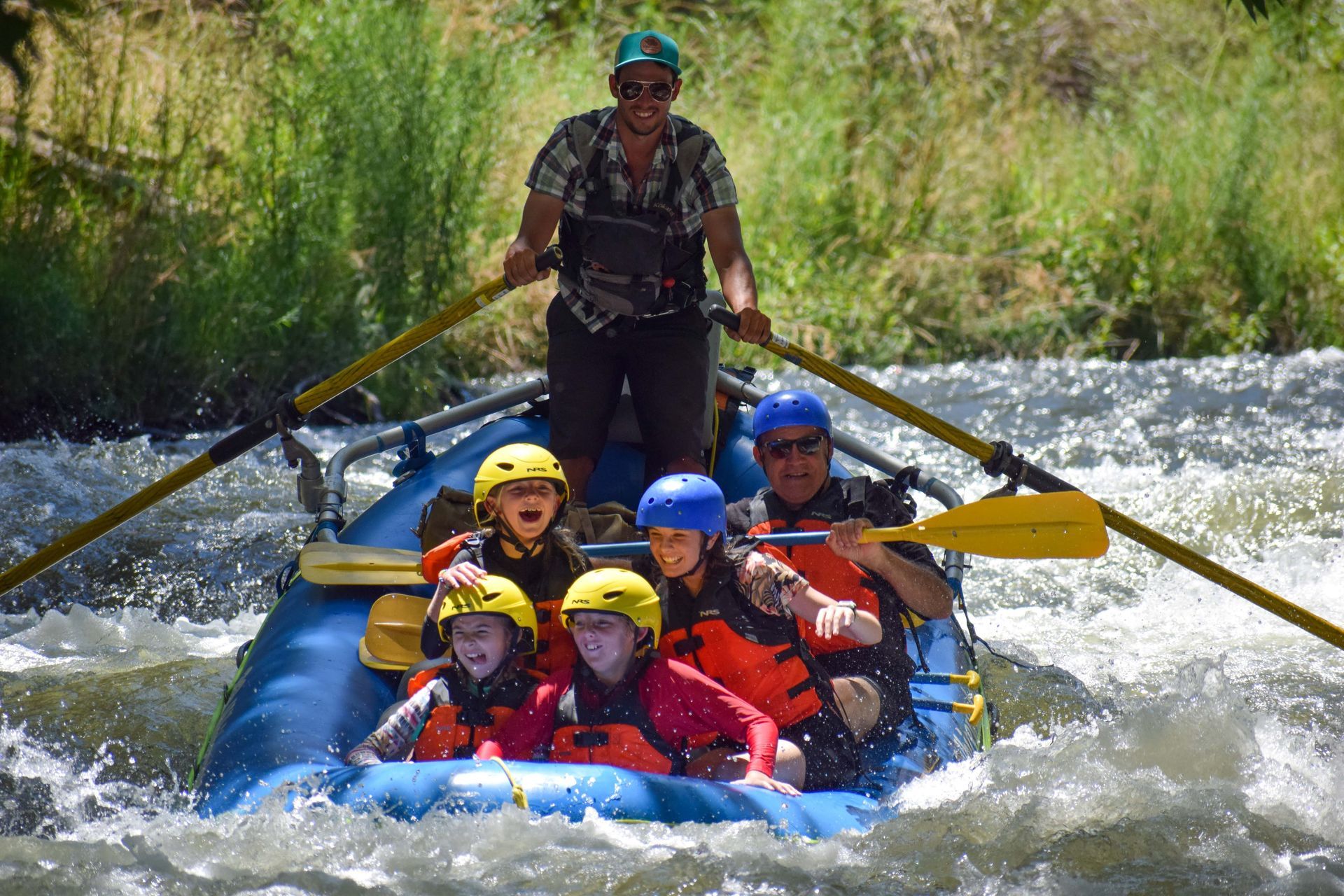 a group of people rafting down a river