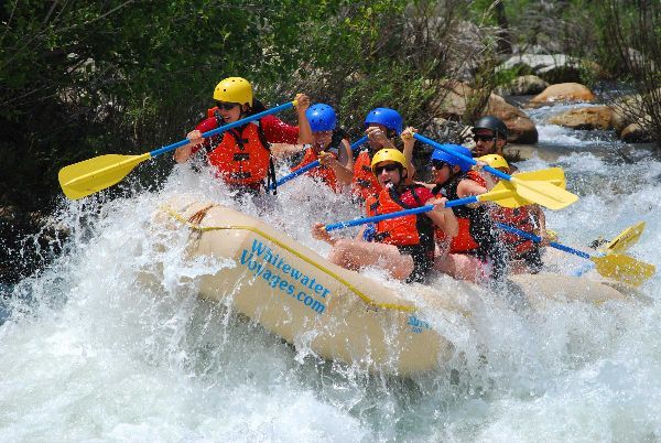 yellow raft going through rapids