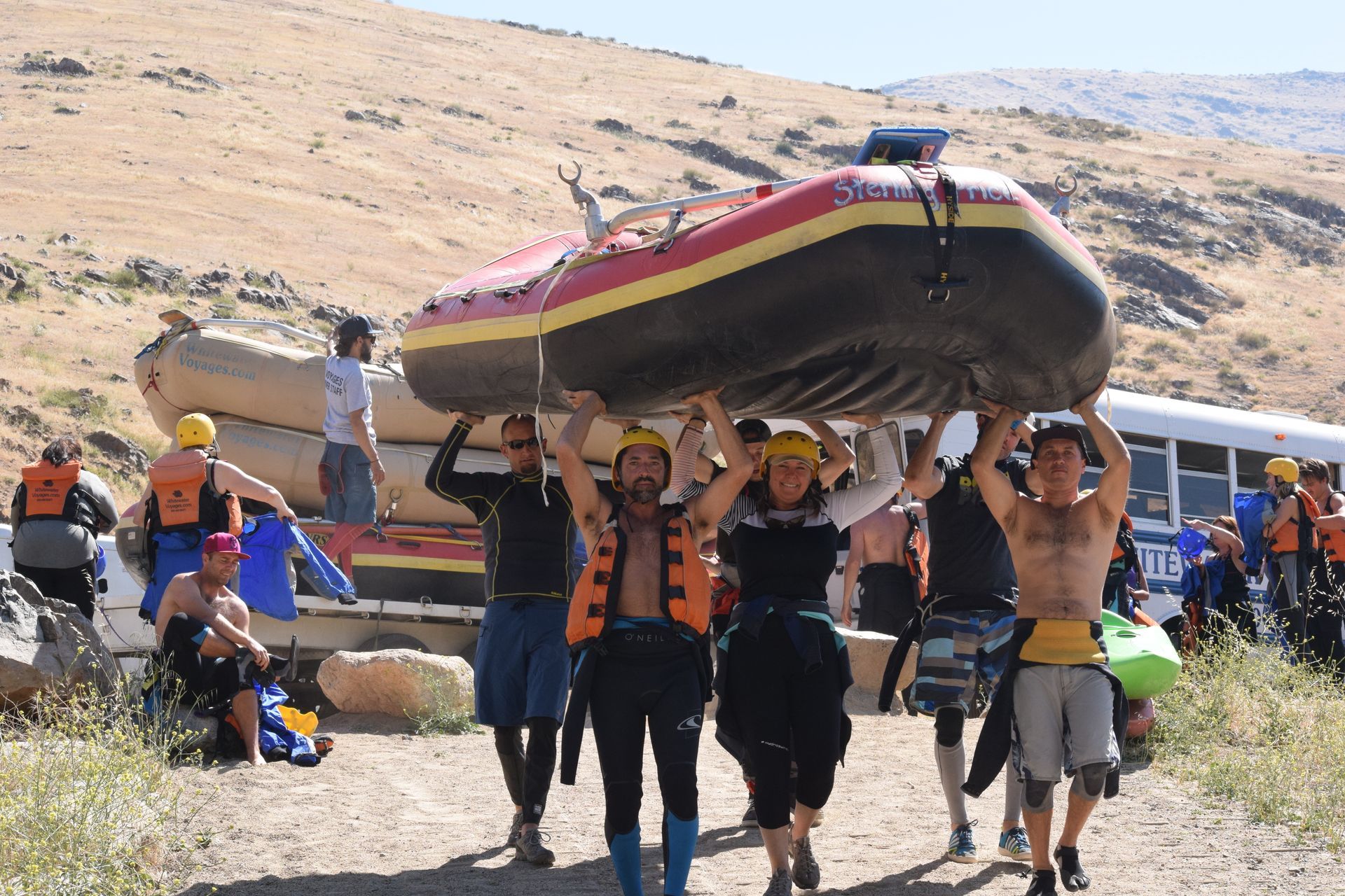 A group of people are sitting on a raft in the water.