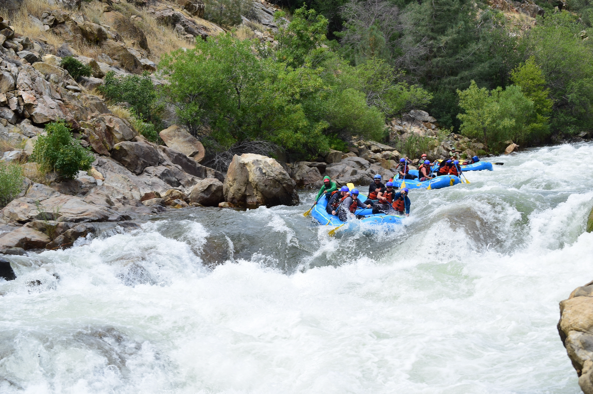 3 rafts going down a rapid