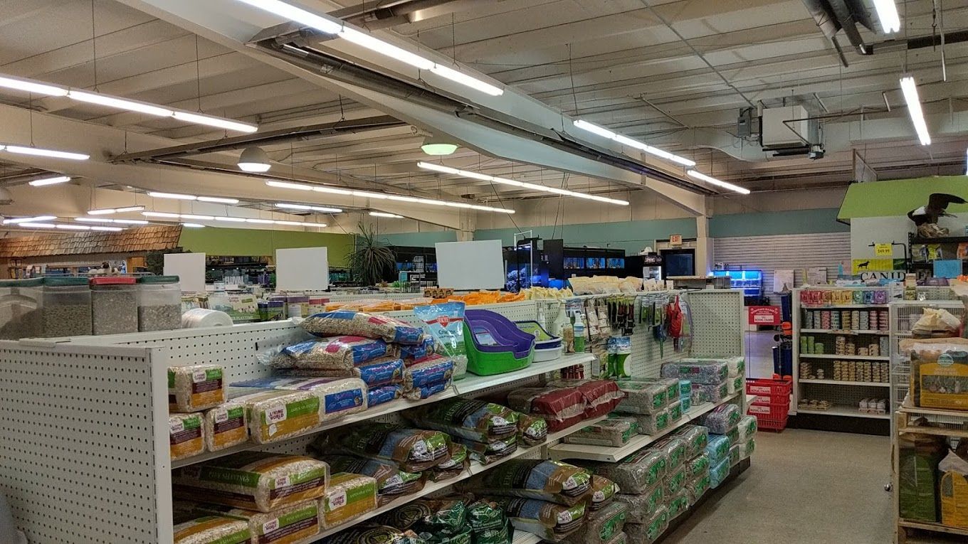 The inside of a pet store filled with lots of products.