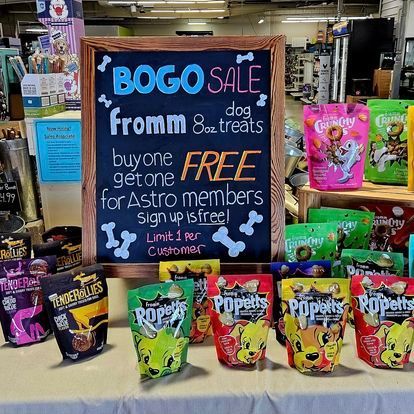 A chalkboard with a sign that says bogo sale from 8 oz treats buy one get one free for astro members sign up is free.