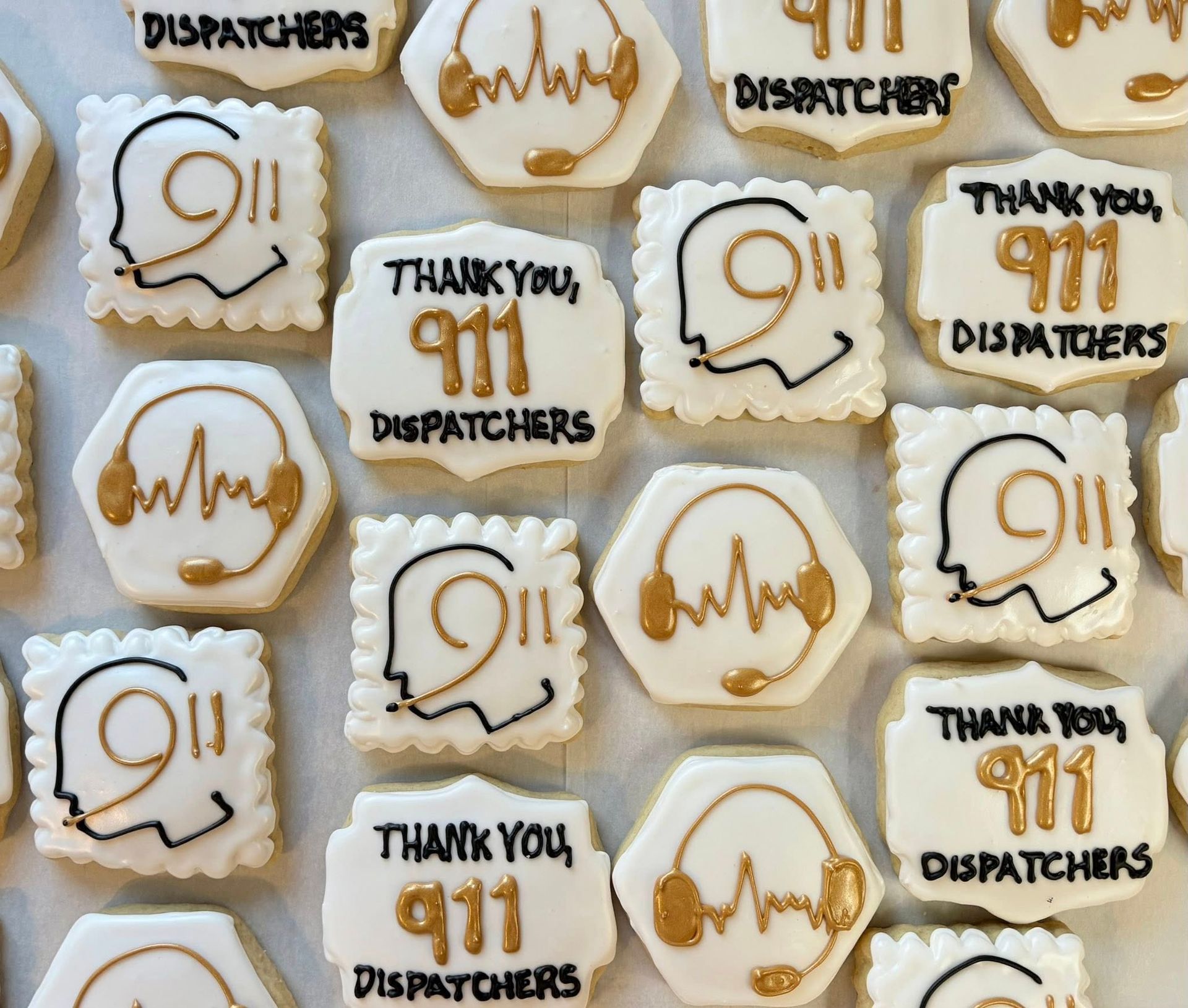 Cookies decorated with “Thank you, 911 Dispatchers” and 911 symbols with a headset.