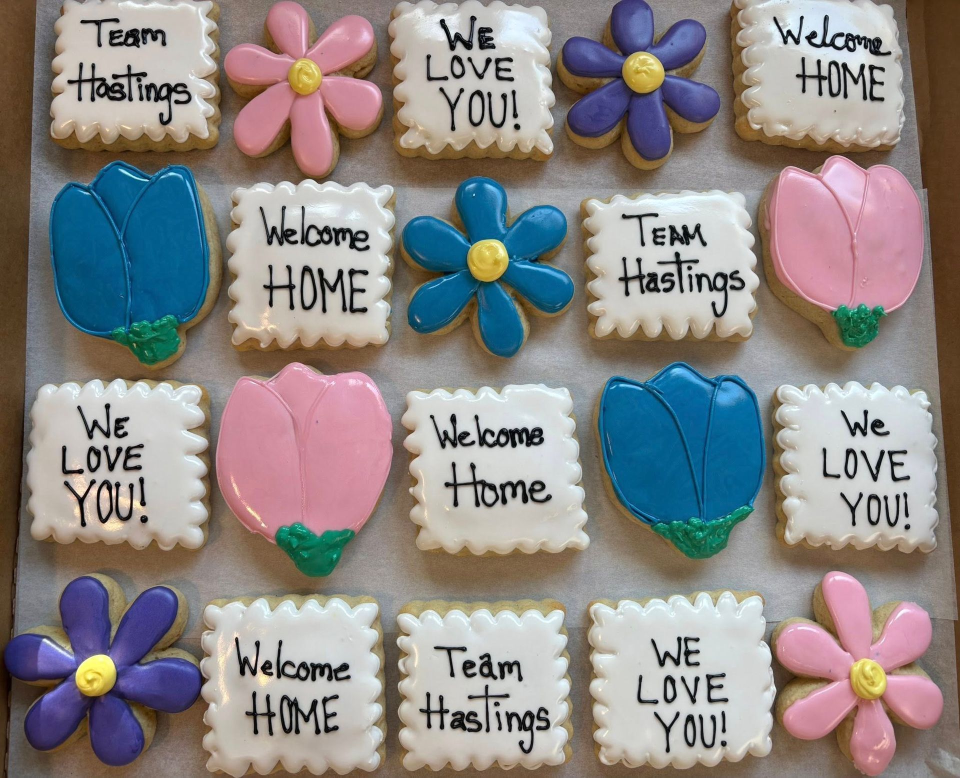 Assortment of decorated cookies in various shapes: flowers and squares with 