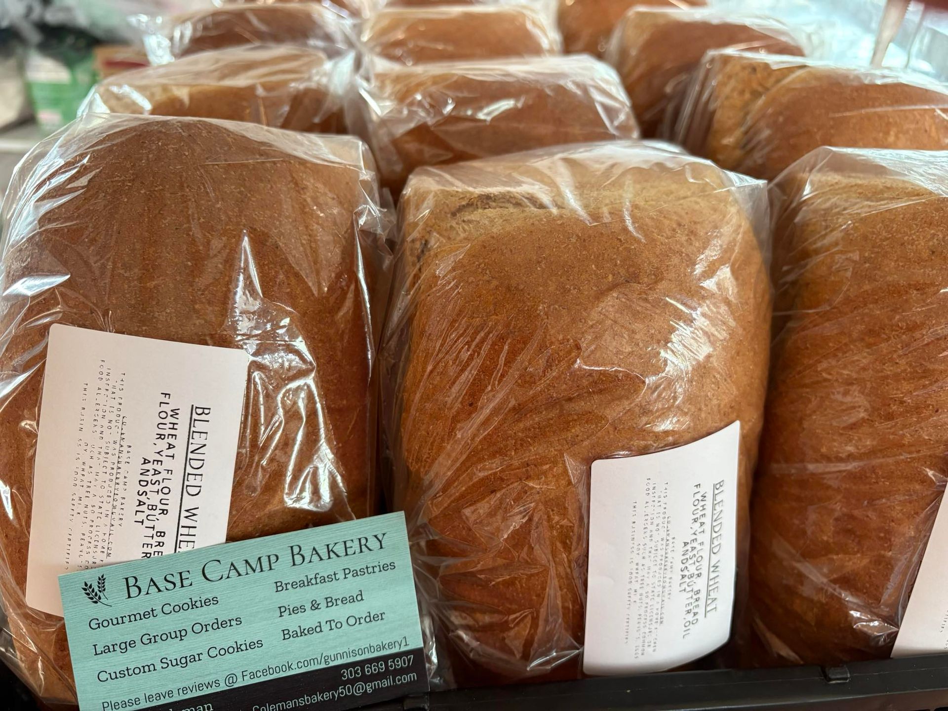 Loaves of bread wrapped in plastic, labeled 