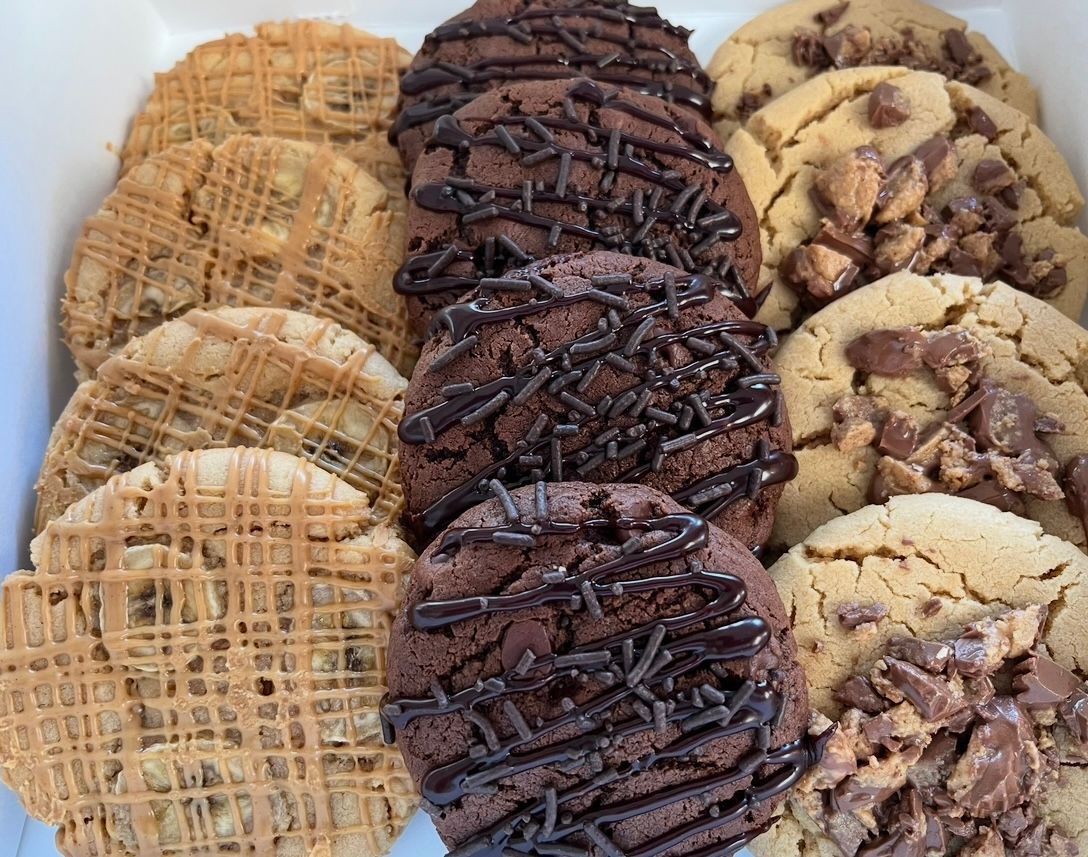 Box of assorted cookies: chocolate drizzled, chocolate chip, and peanut butter flavors.