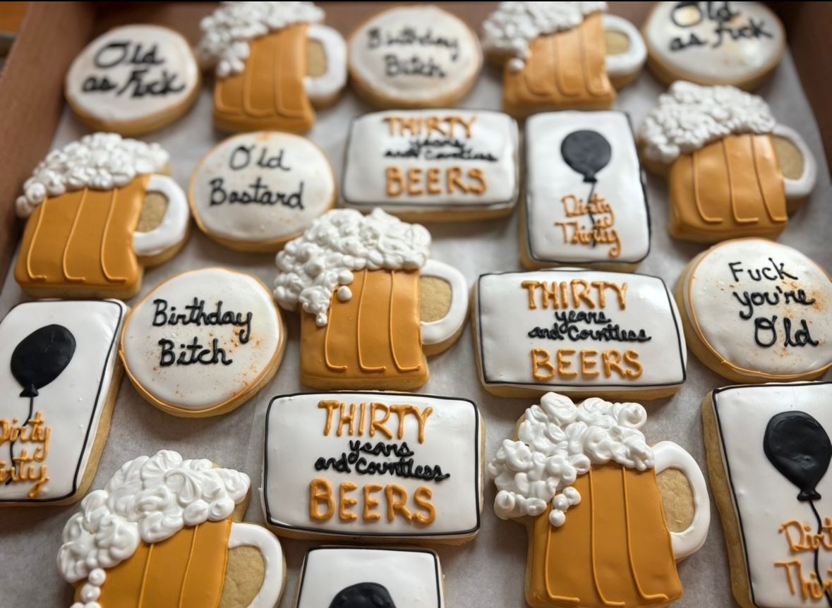Box of decorated sugar cookies, beer mugs, and birthday greetings.