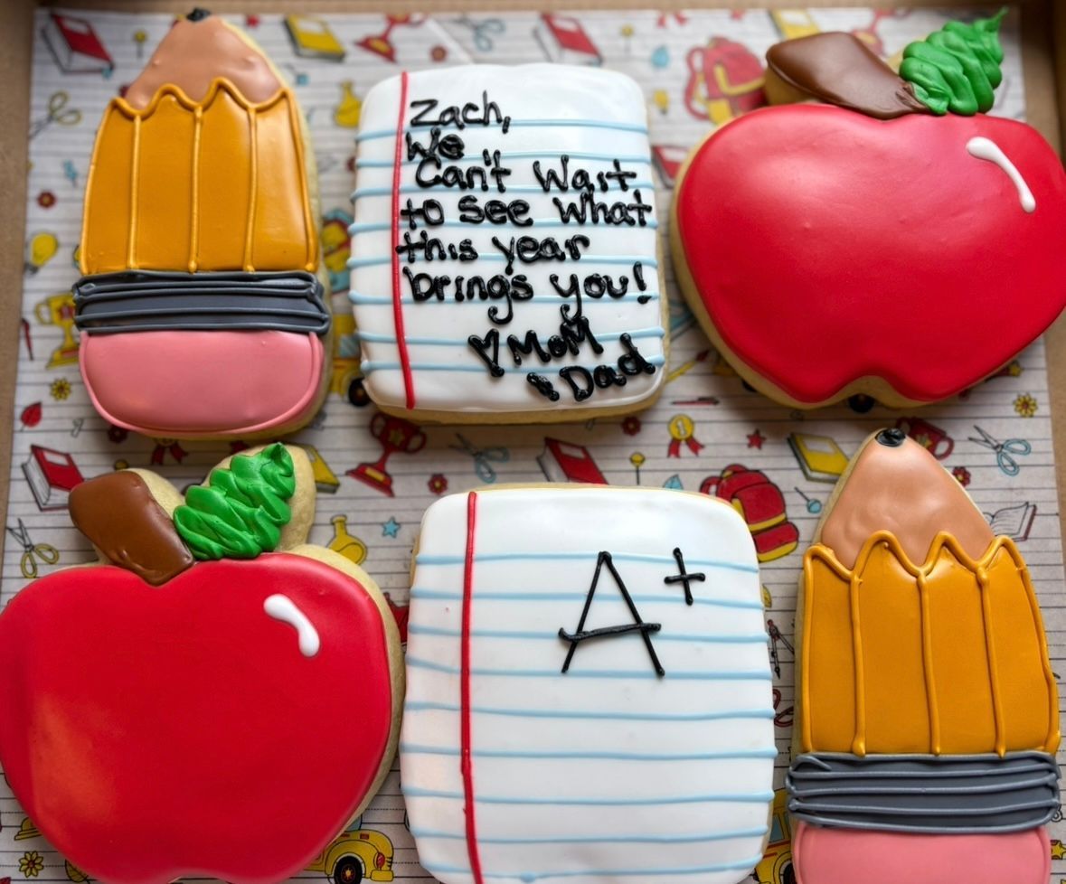 Back-to-school cookies: pencils, apples, and notepaper with messages, decorated with icing.
