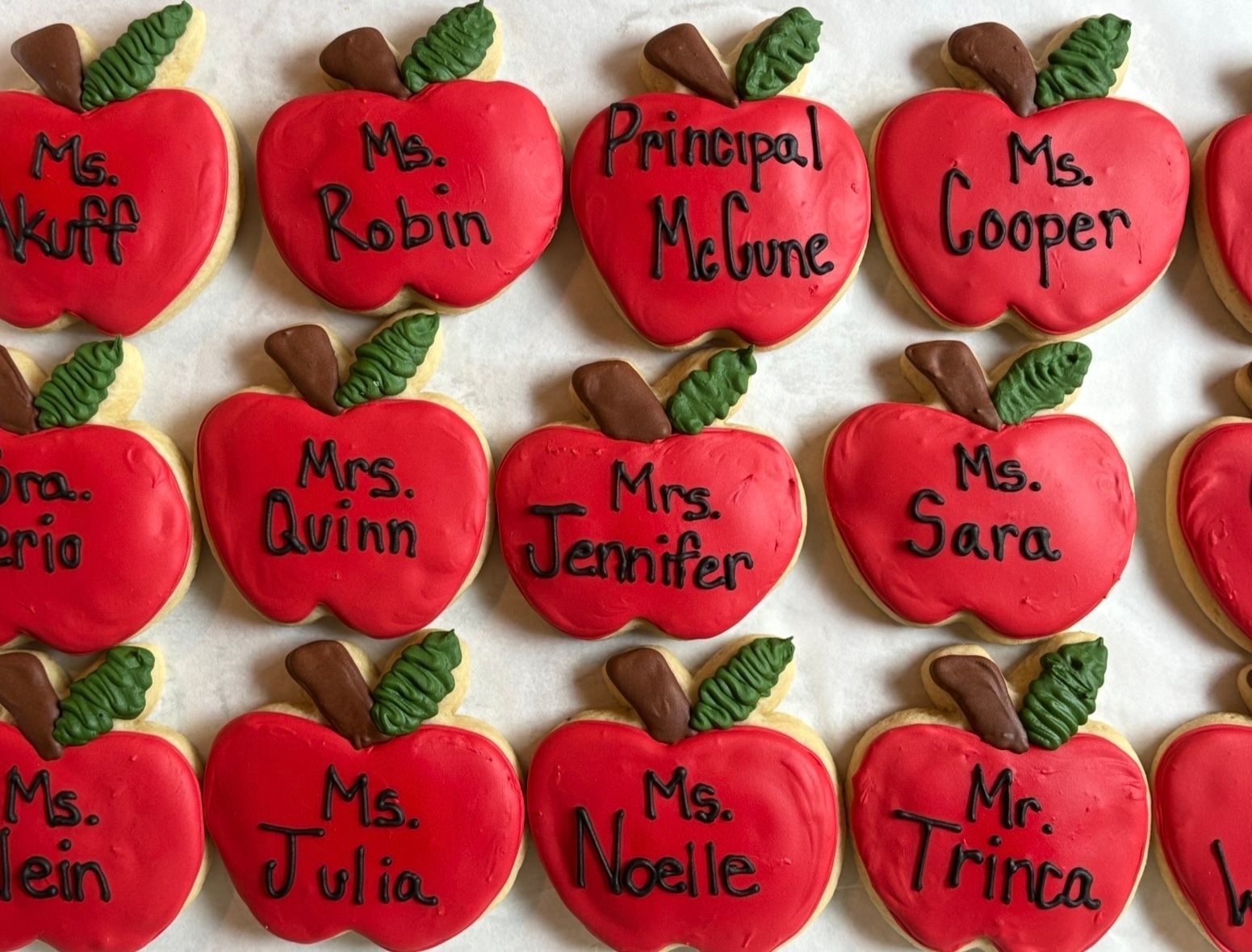 Red apple cookies iced with teachers' names.