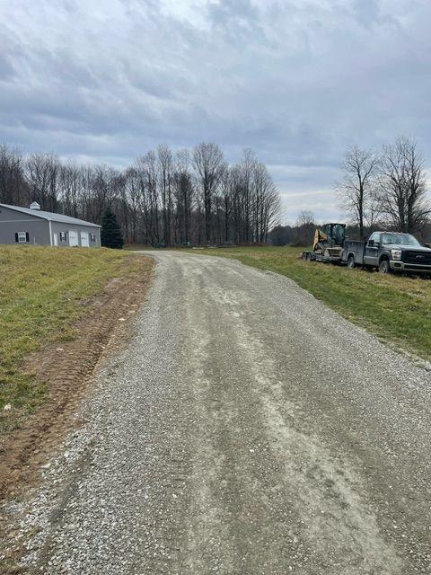 Dirt Road With Trucks Parked on the Side of It
