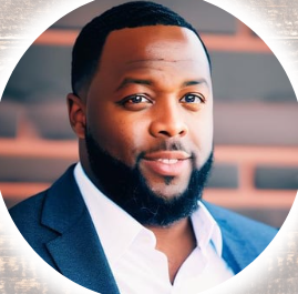 A man with a beard is wearing a suit and white shirt