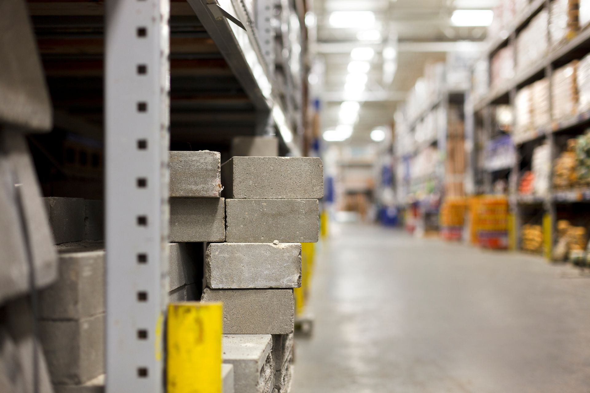 A close-up of concrete blocks stacked on a warehouse shelf. A close-up of concrete blocks stacked on a warehouse shelf.