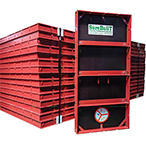 Red metal concrete formwork stacked for construction.