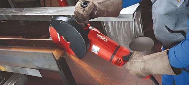 Person cutting metal, showcasing precision using hilti tools, a professional grinder in action.