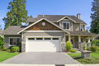 the front of a house with a white garage door