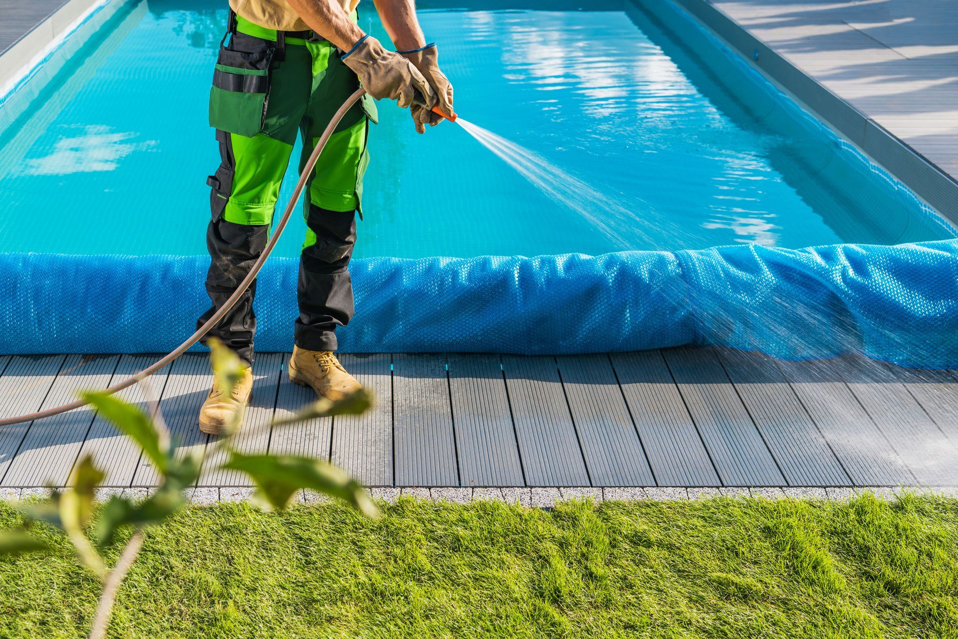 a man is spraying a pool with a hose