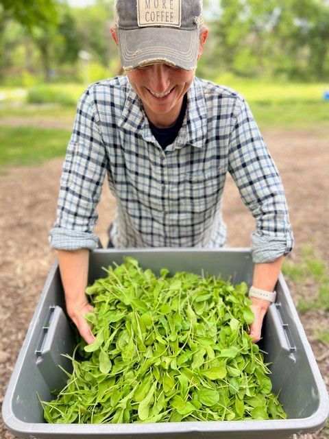 Heather with arugula at Red Gate Ranch