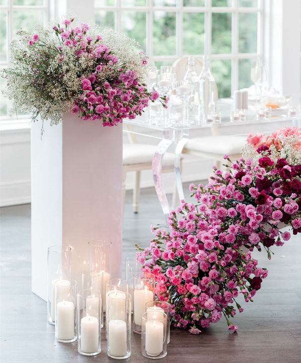 A table is set with vases of flowers and candles