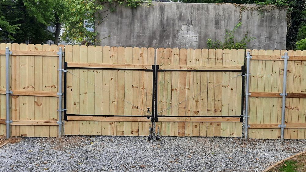 A wooden fence with a gate attached to it.