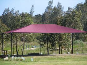 A Large Purple Tent Is Sitting In The Middle Of A Grassy Field — Shades of Blue In North Wyong, NSW